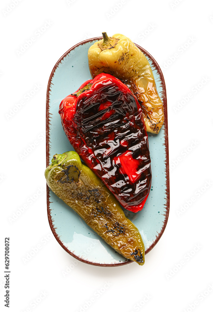 Plate with different grilled peppers on white background