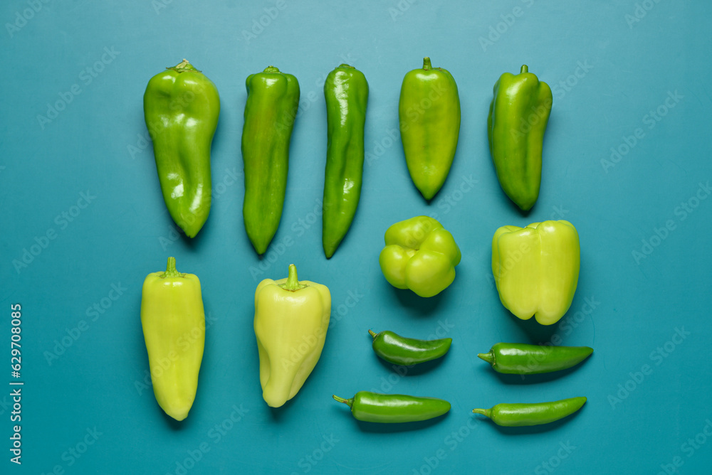 Different fresh peppers on blue background