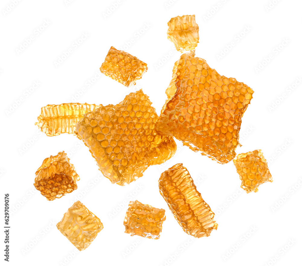 Flying sweet honeycombs on white background