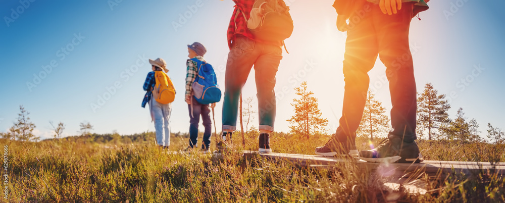 Family walking on the footpath on the bog in Estonia.