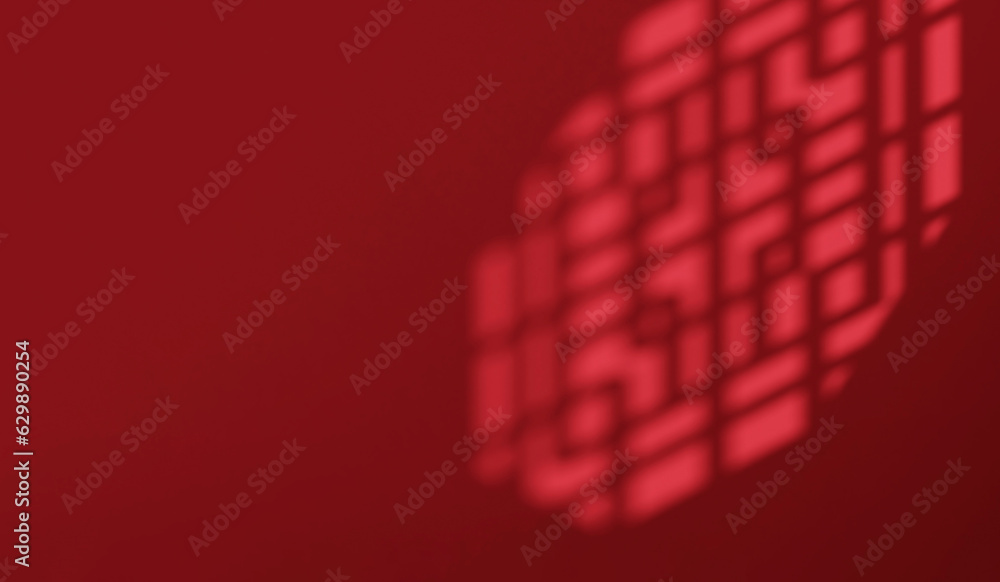 Sunlight and shadow of Chinese window grill on maroon red background with space for Luxury Asian fas