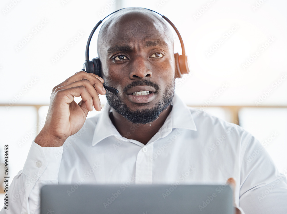 Black man thinking while consulting on laptop in call center for customer service, advisory and ques