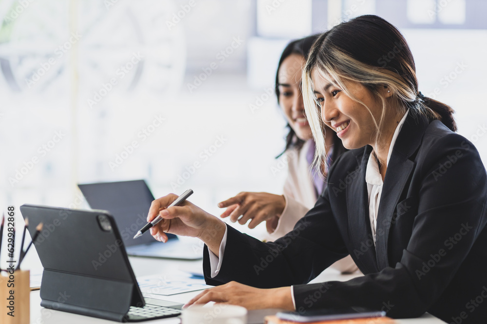 Colleagues working together in the office. Businesswoman discussing with colleagues at work about wo