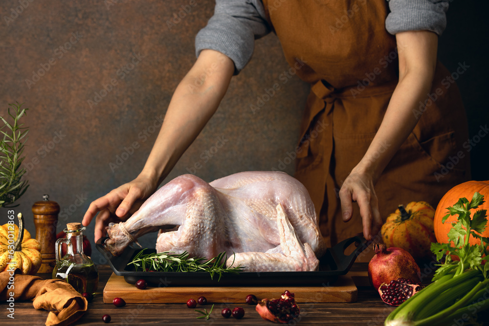 Woman preparing a turkey for  family Thanksgiving dinner