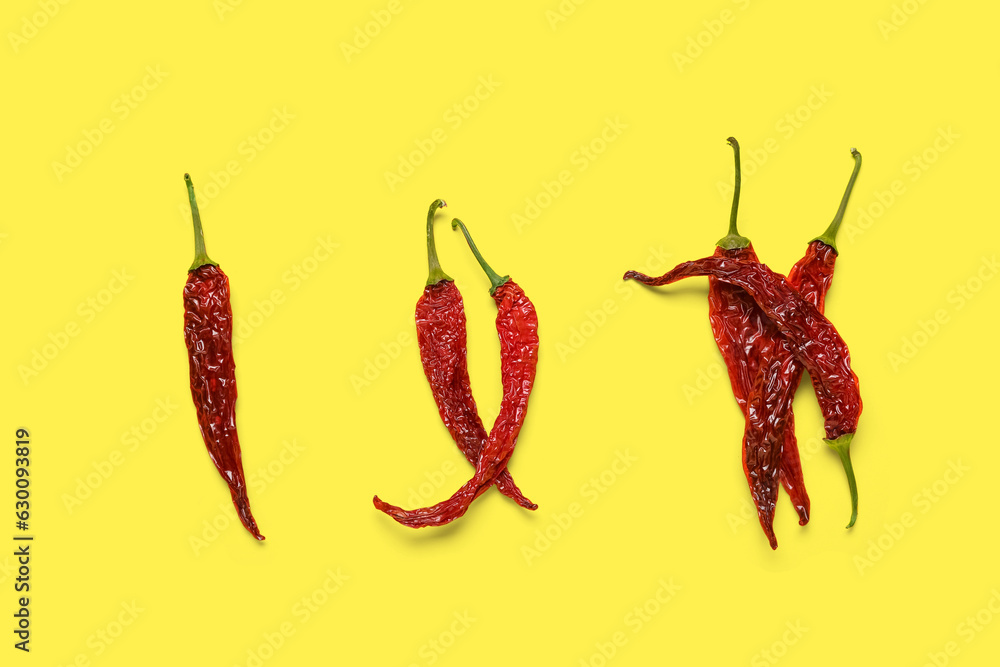 Dry hot chili peppers on yellow background