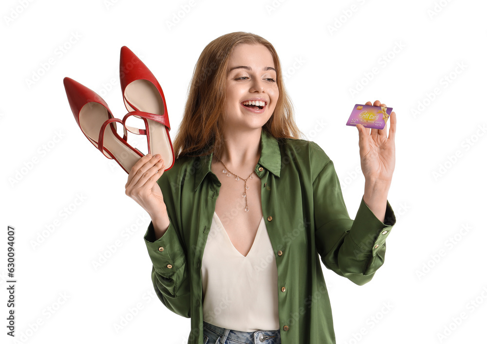 Young woman with stylish shoes and credit card on white background