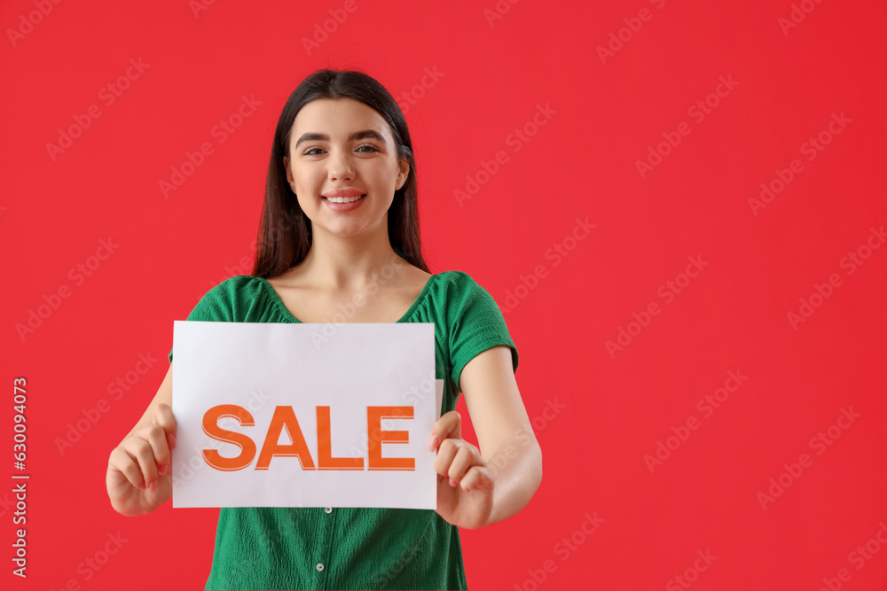 Female seller with sale sign on red background