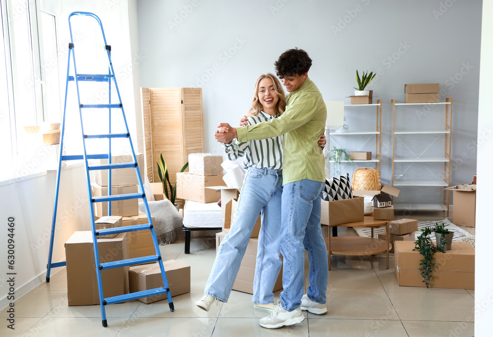 Young couple dancing in bedroom on moving day