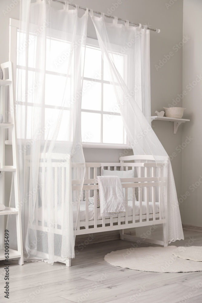 Interior of stylish childrens bedroom with crib