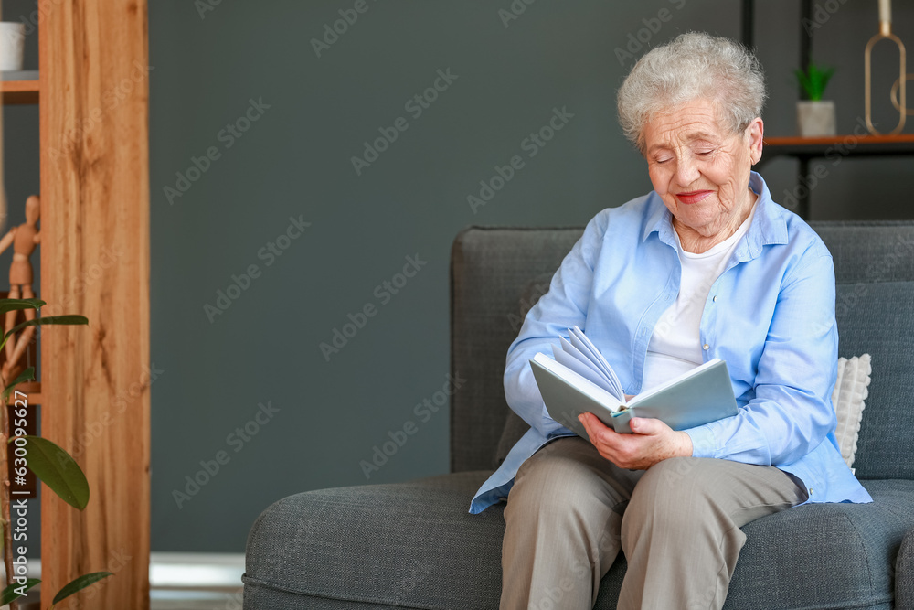 Senior woman reading book at home