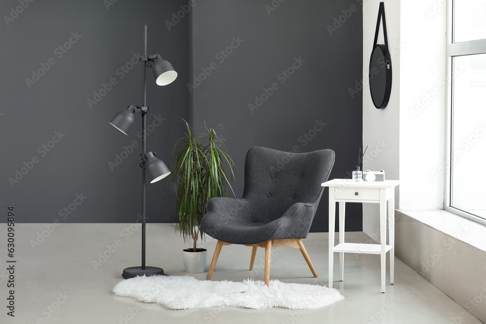 Interior of modern living room with black armchair and lamp