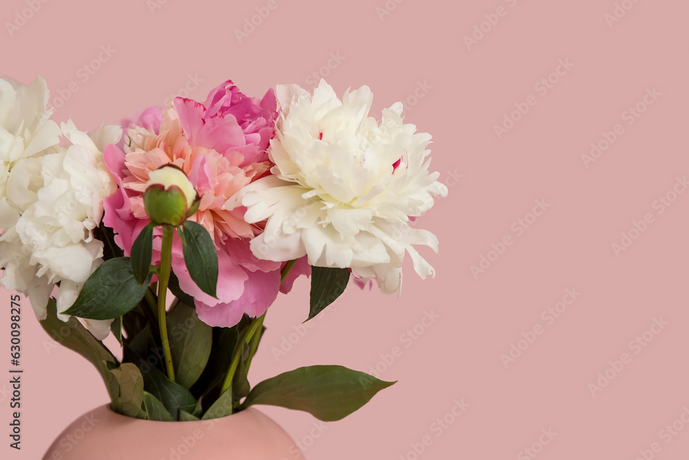 Vase of peonies on pink background, closeup