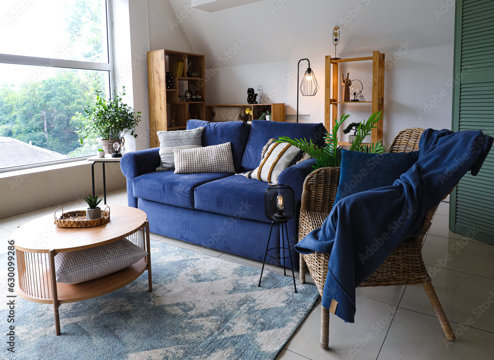 Interior of stylish living room with glowing lamps, sofa and armchair