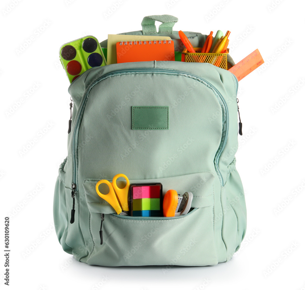 Green school backpack with different stationery on white background