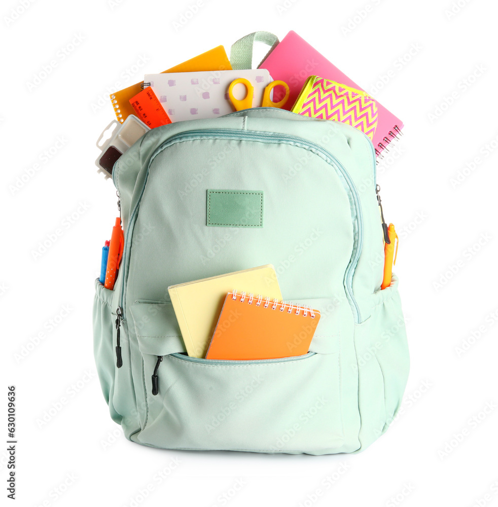 Green school backpack with notebooks, pencil case and scissors on white background