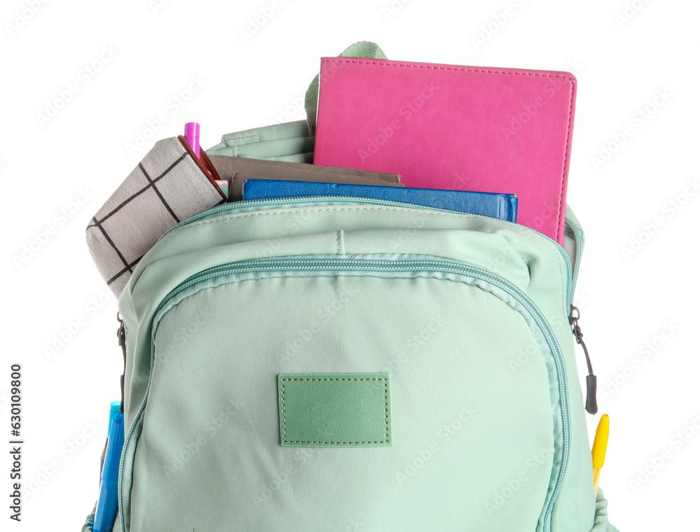 Green school backpack with notebooks and pencils case on white background