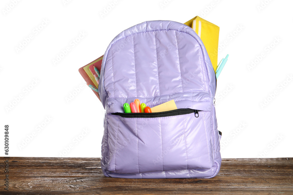 Lilac school backpack with notebooks, pencil case and markers on wooden table near white background