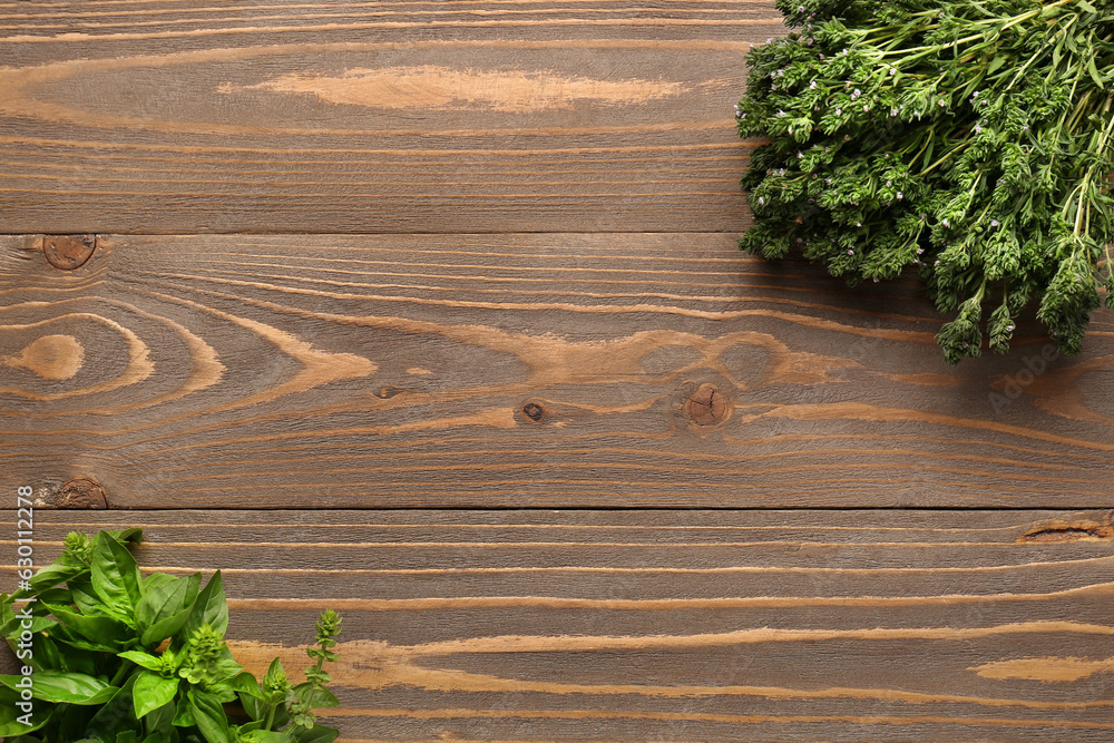 Fresh thyme and basil on wooden background