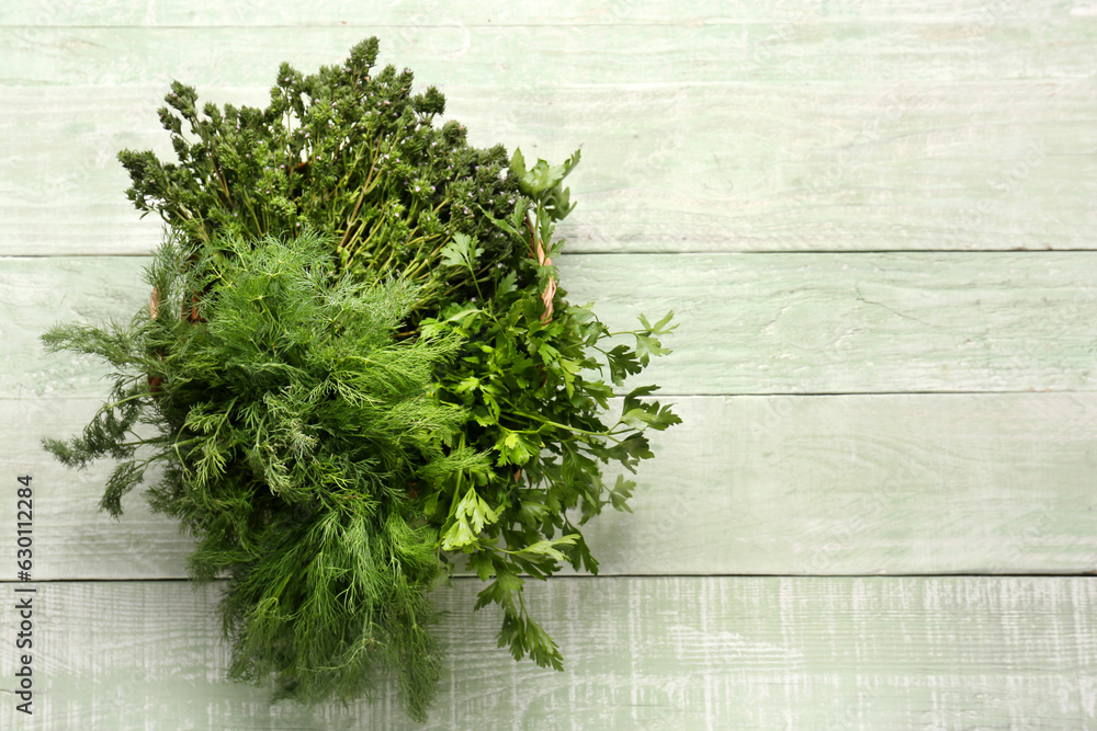 Basket with fresh herbs on color wooden background