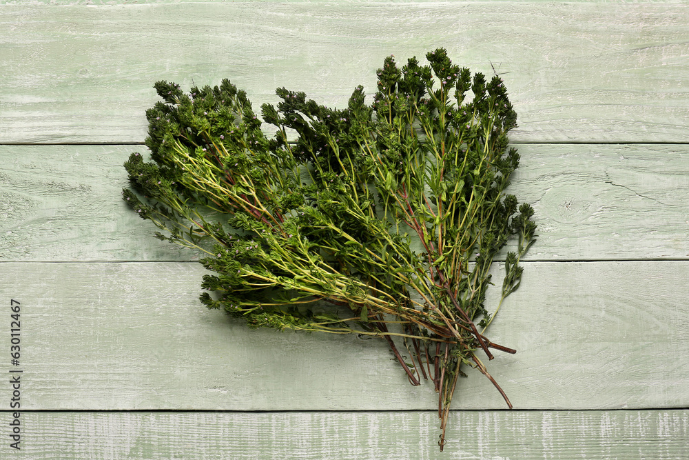 Fresh thyme on color wooden background