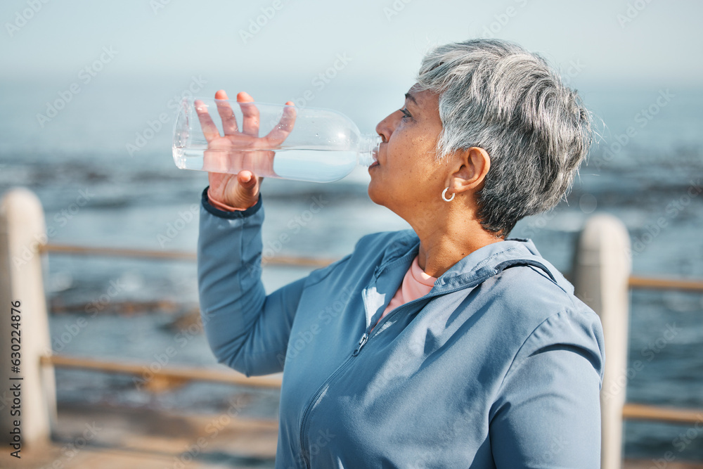 Outdoor, fitness or senior woman drinking water for hydration, wellness and thirsty on beach run, tr