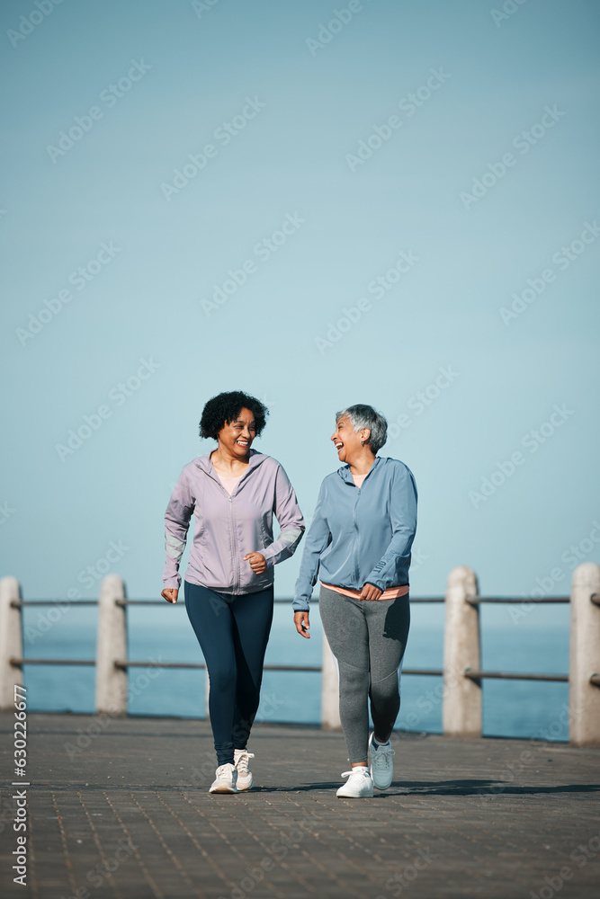 Exercise, walking and senior women by ocean for healthy body, wellness and cardio on promenade. Spor