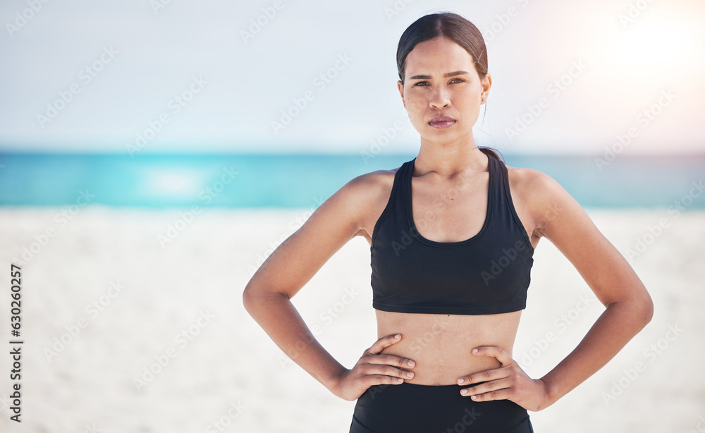 Portrait, fitness and serious woman at a beach for training, sports and exercise, running and workou