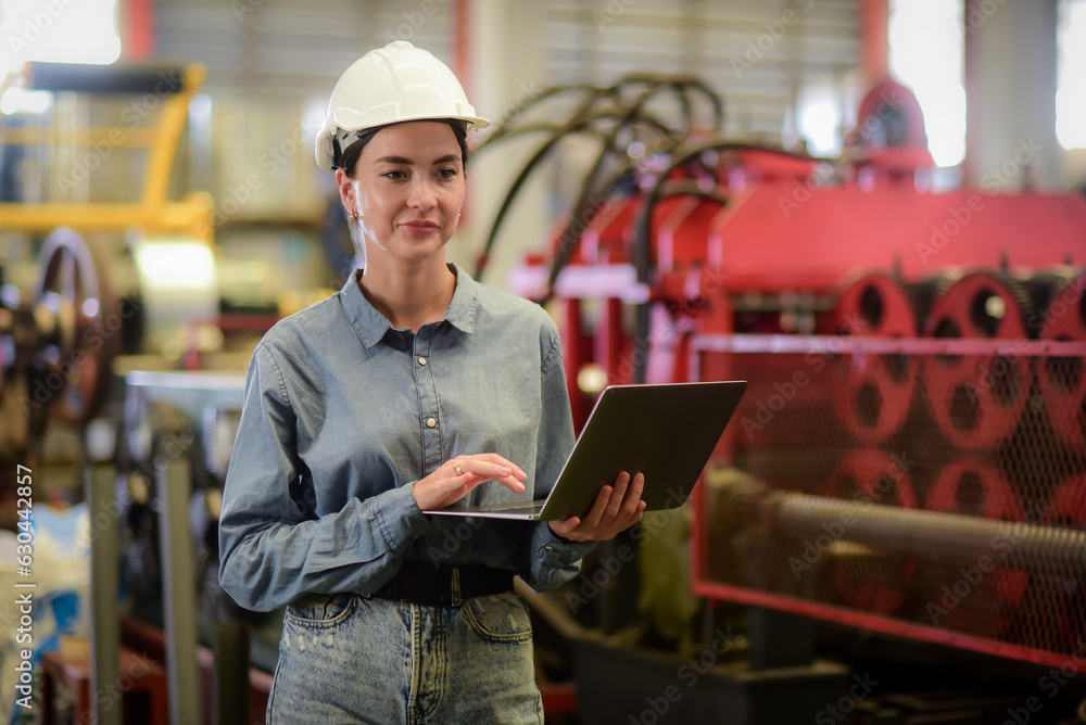 Caucasian female programmer,computer engineer wearing helmet working use laptop Online information, 