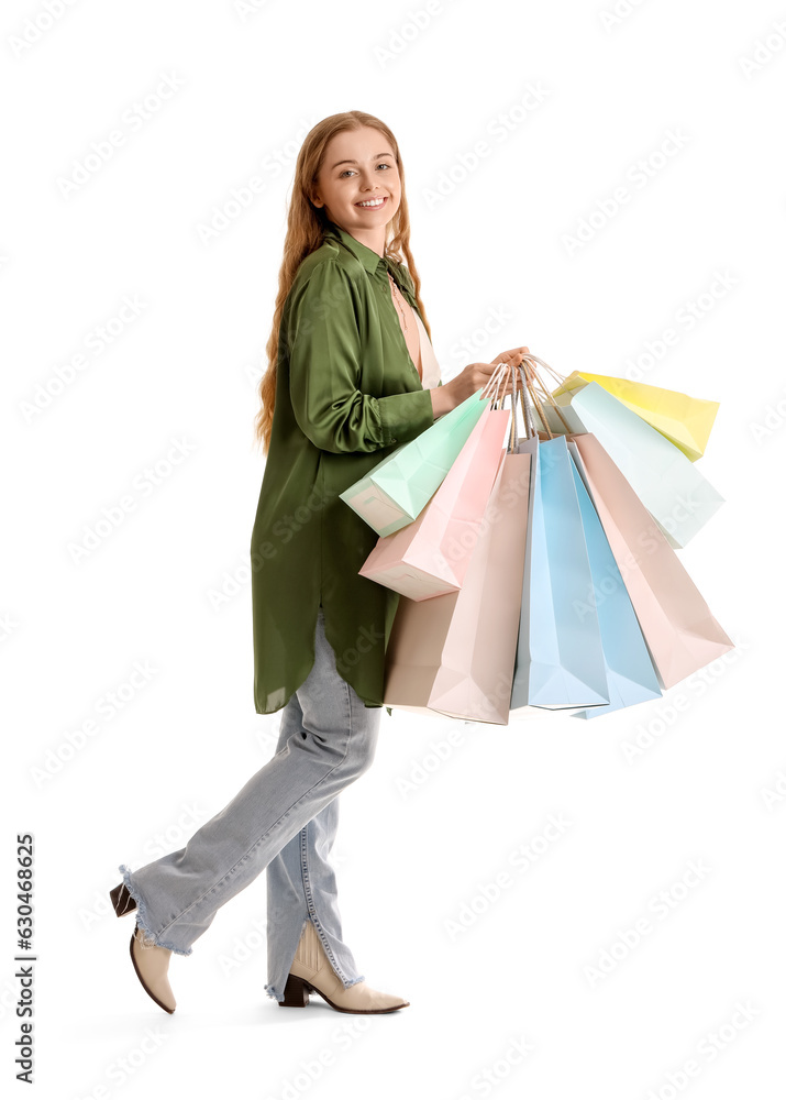 Young woman with shopping bags on white background