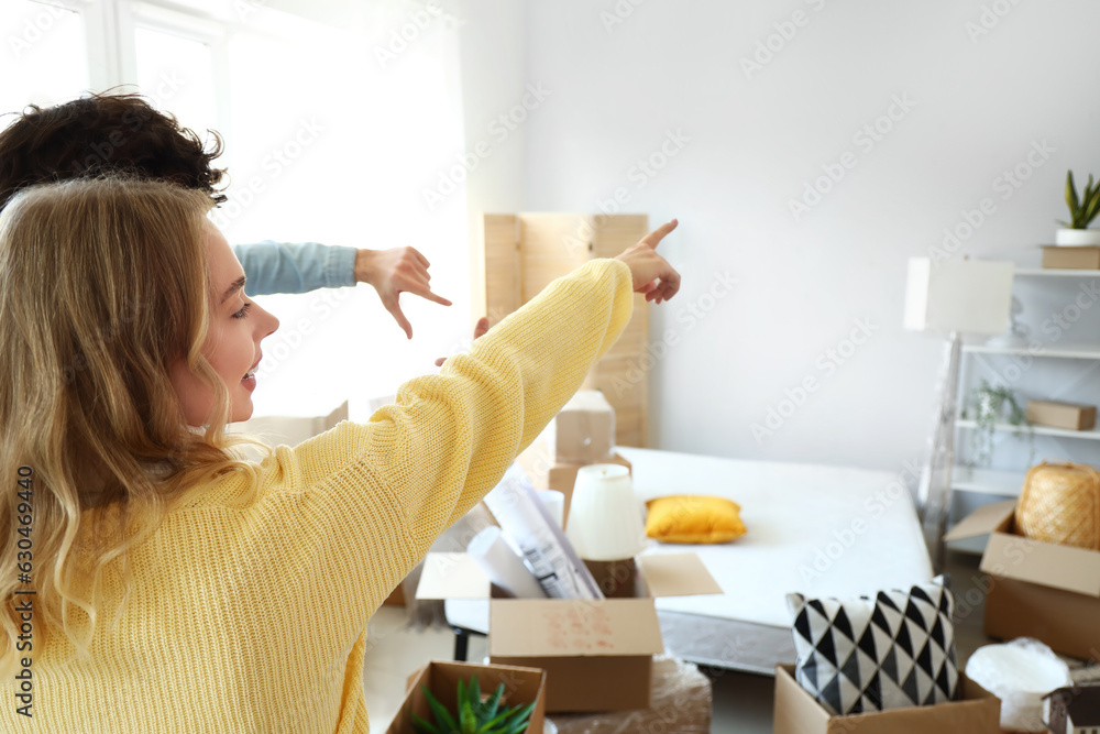 Young couple in bedroom on moving day