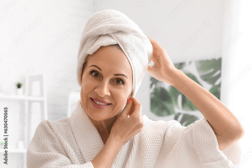 Mature woman with towel in bathroom, closeup