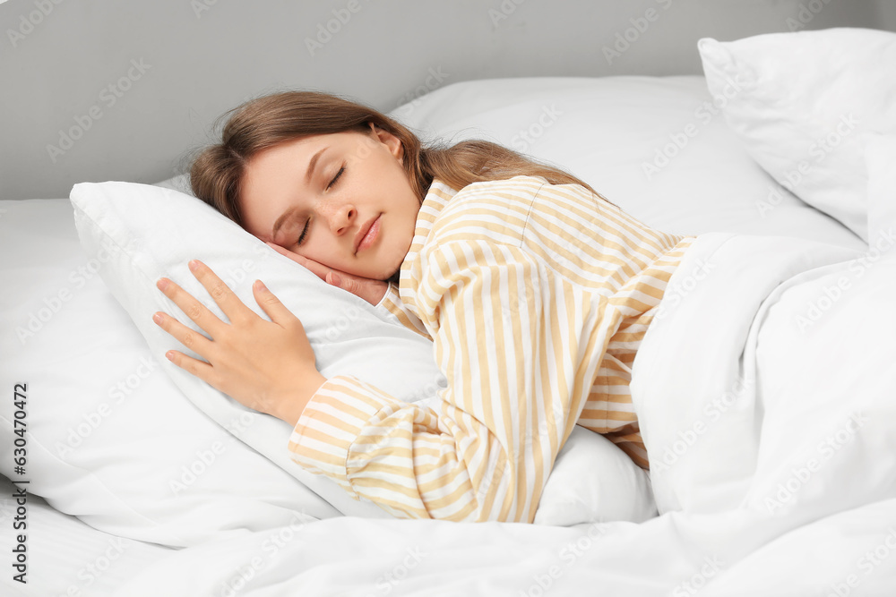 Morning of pretty young woman sleeping in soft bed