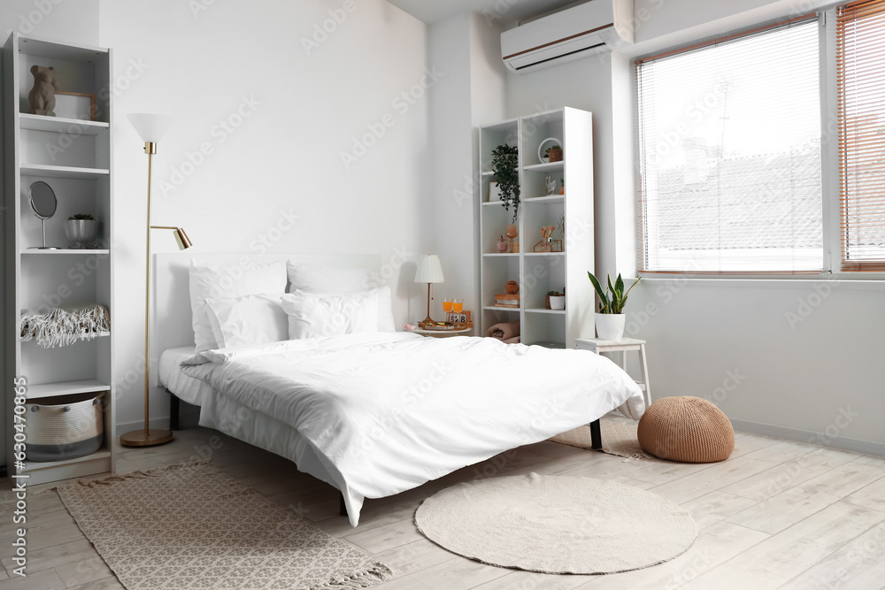 Interior of light bedroom with breakfast on table