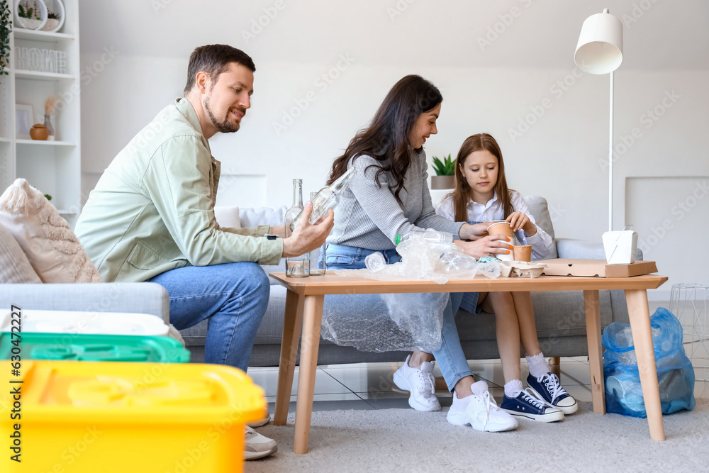 Family sorting garbage at home