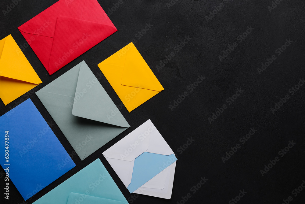 Composition with colorful envelopes on dark background