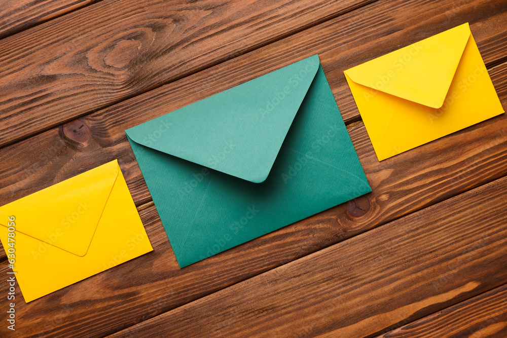 Set of colorful envelopes on wooden background