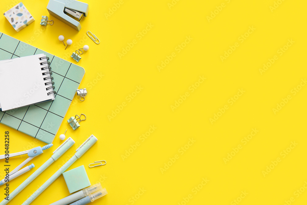 Different school stationery and notebooks on yellow background