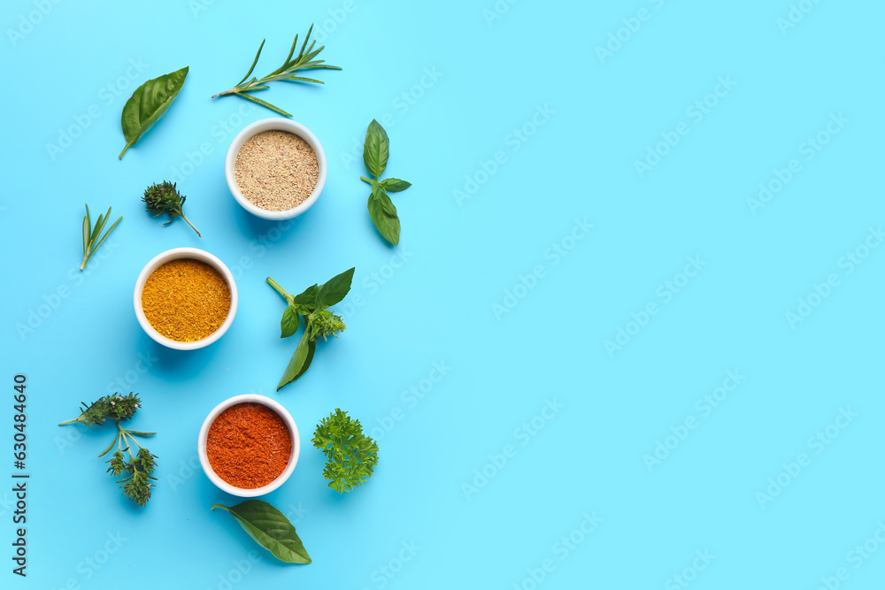 Composition with bowls of fresh aromatic spices and herbs on color background