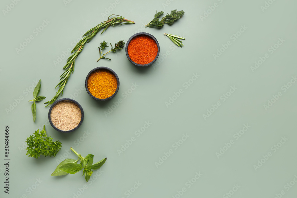 Composition with bowls of fresh spices and herbs on color background