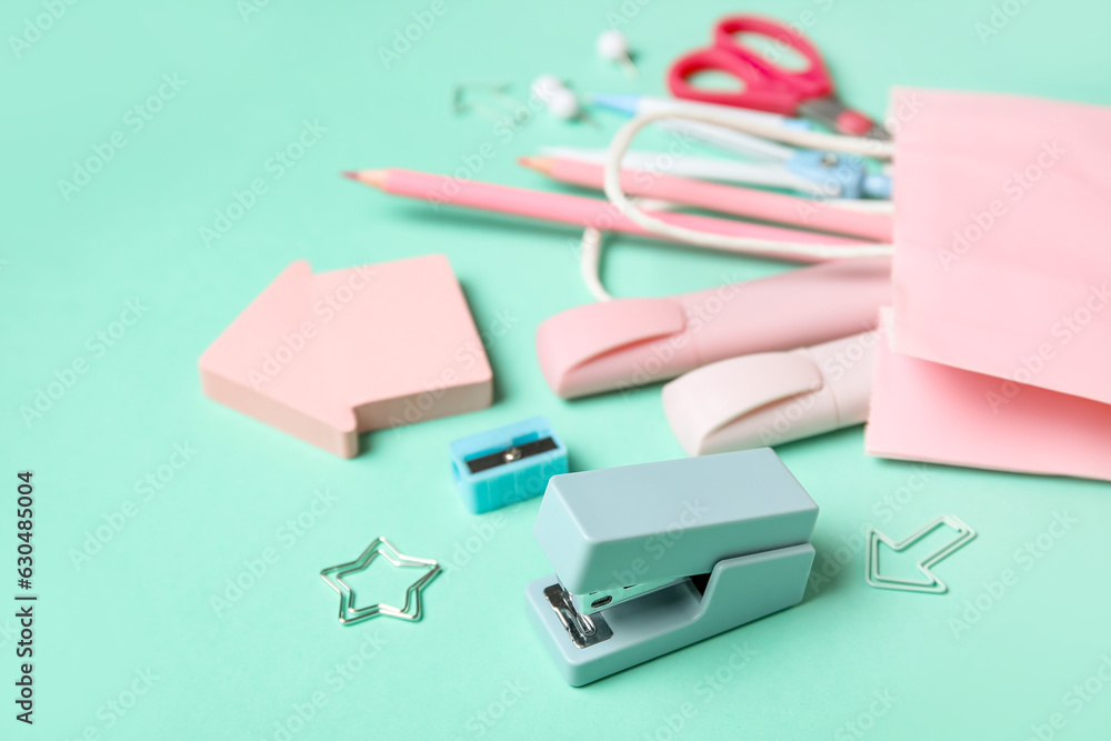 Composition with paper bag and stationery on color background