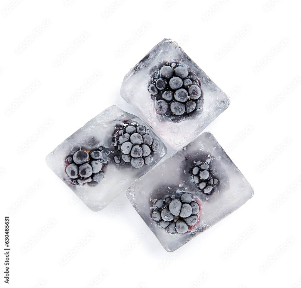 Frozen blackberries in ice cubes on white background