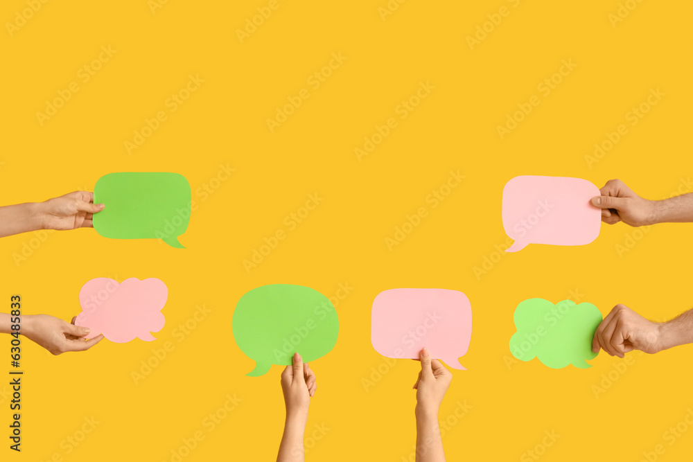 Different hands with speech bubbles on yellow background