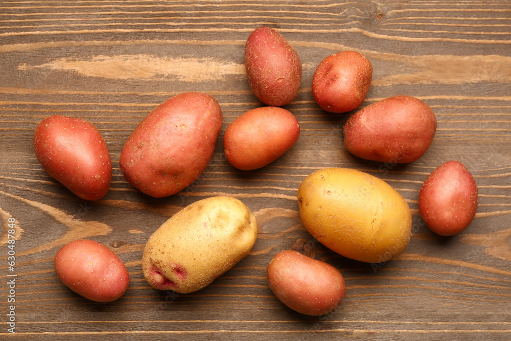 Fresh raw potatoes on wooden background