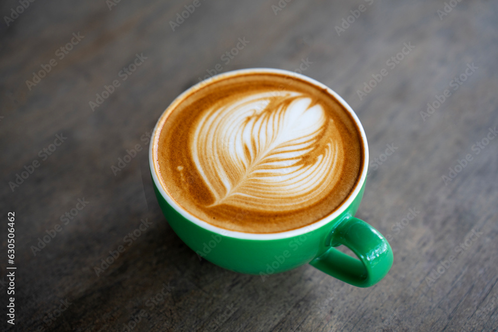 Hot coffee latte a cup of coffee cupucino on wood table background with warm morning sunlight concep