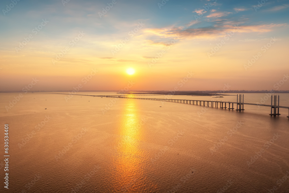 Aerial photo of Qingdao Jiaozhou Bay Cross Sea Bridge under sunset..