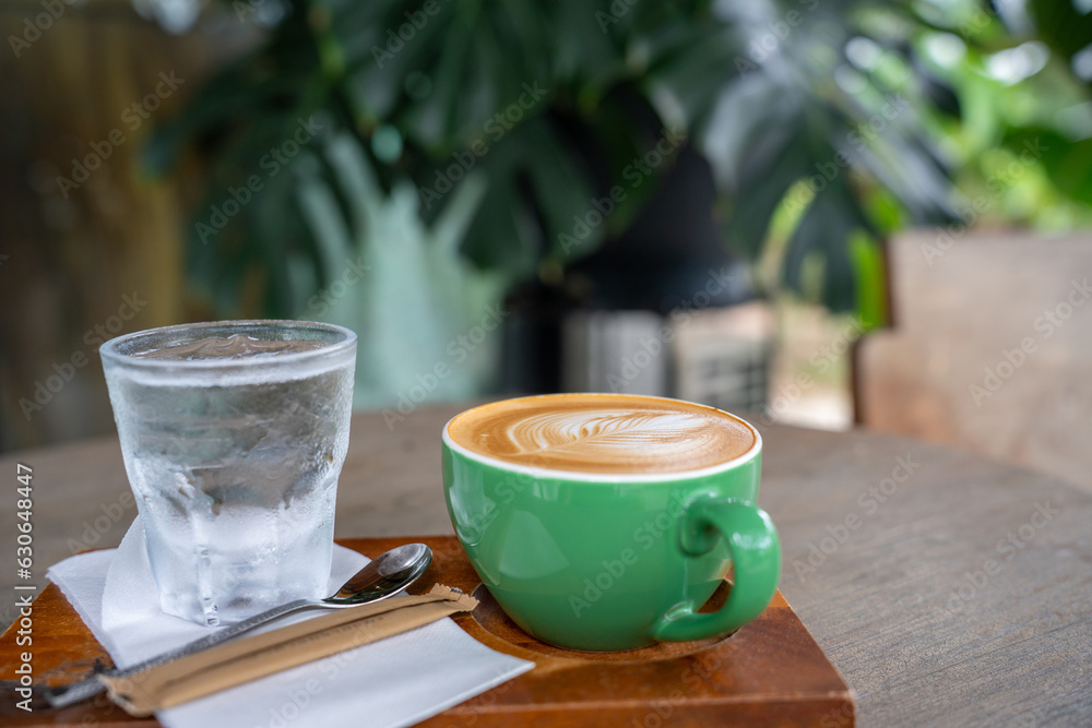 Hot coffee latte a cup of coffee cupucino on wood table background with warm morning sunlight concep