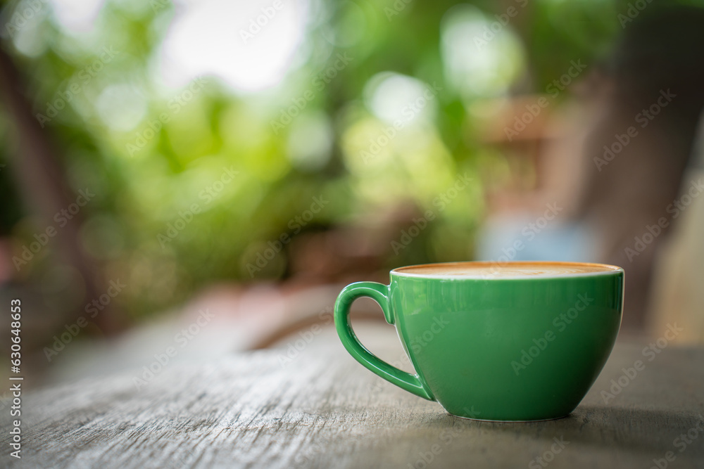 Hot coffee latte a cup of coffee cupucino on wood table background with warm morning sunlight concep