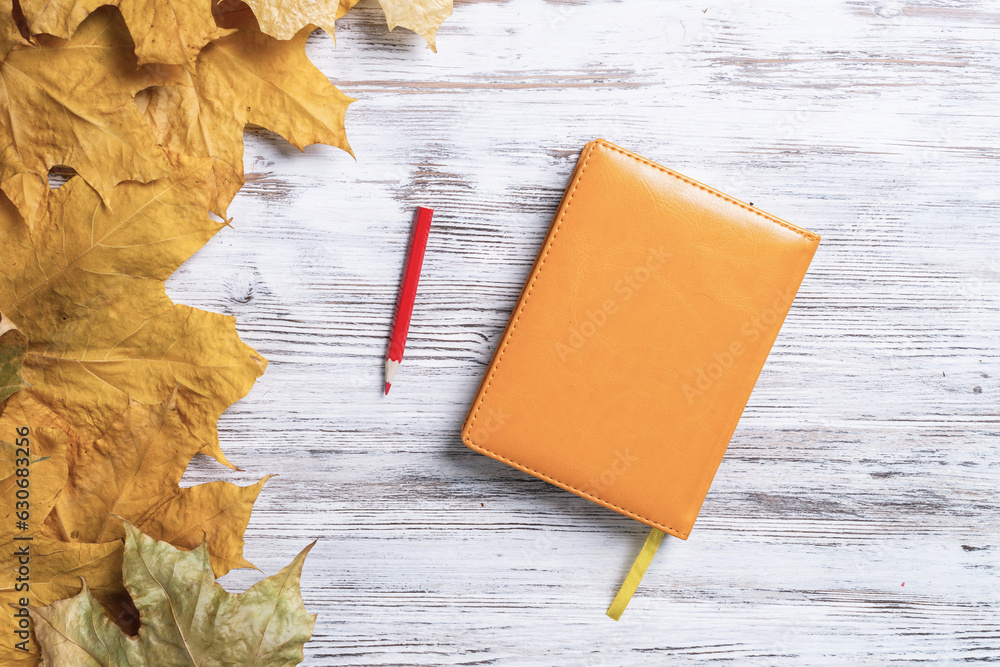 Notebook and pen lies on vintage wooden desk