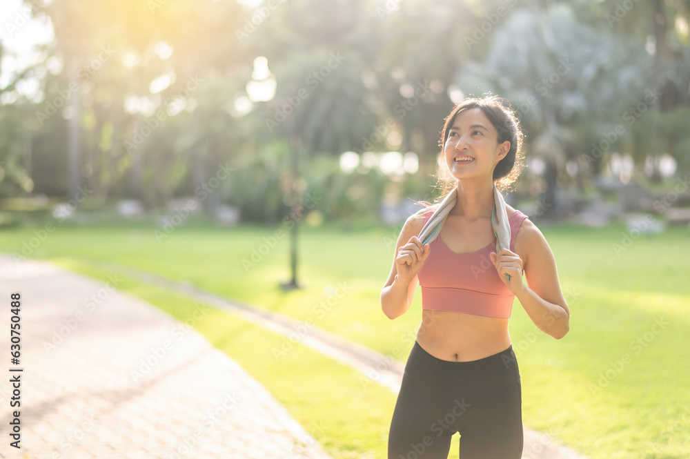 beauty of a fit and happy 30s young Asian woman in sportswear, enjoying a refreshing sunset run in n