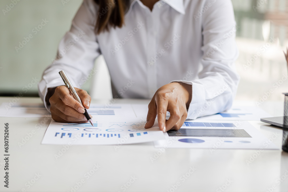 Businesswoman working with laptop and analyzing financial and accounting documents. Business woman w